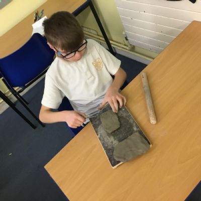 Children making clay lizards